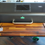 Grill with wooden lid on a wooden floor