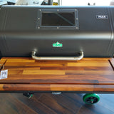 Grill with wooden lid on a wooden floor