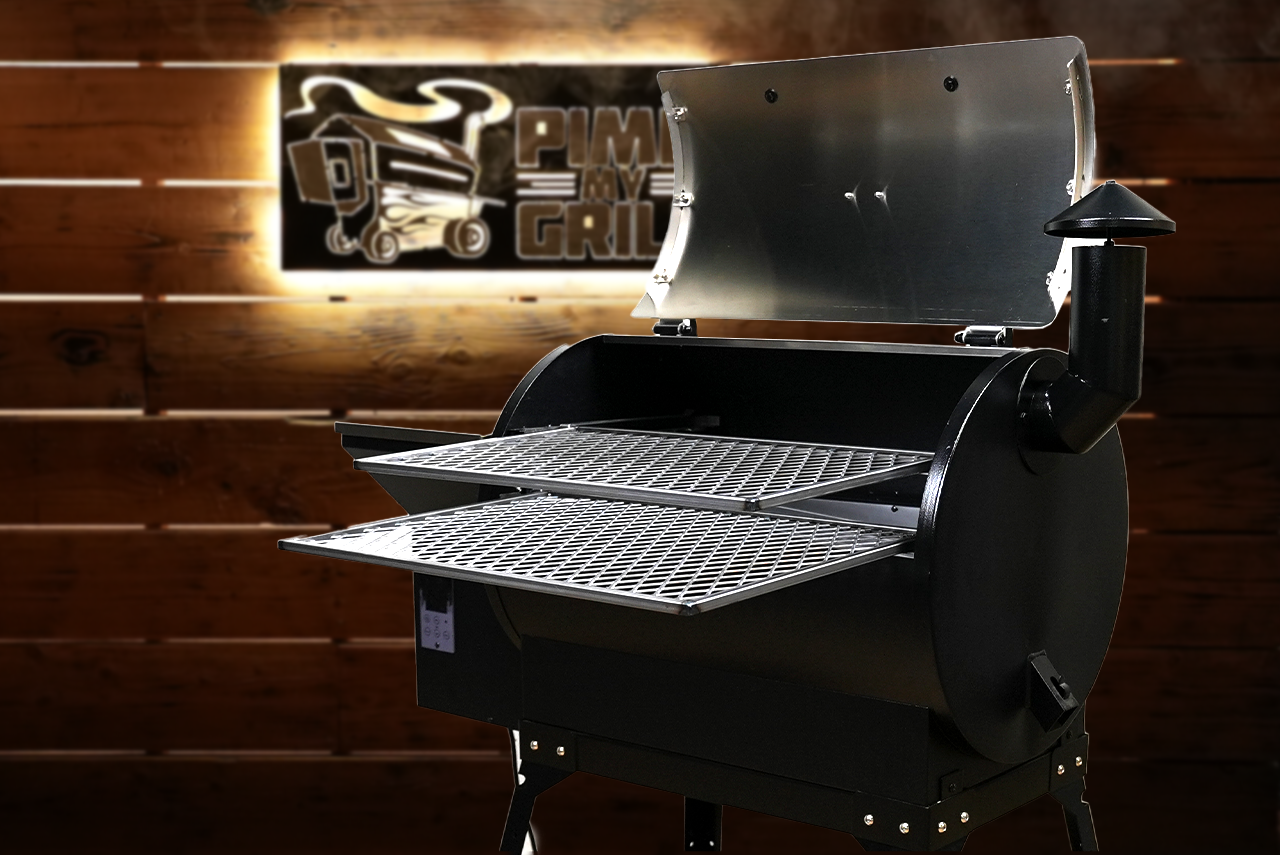 Black grill with open lid on a wooden background featuring a PMG logo.