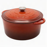 Red enameled cast iron Dutch oven with a lid on a white background