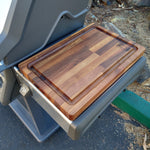 Wooden cutting board on a portable stand outdoors