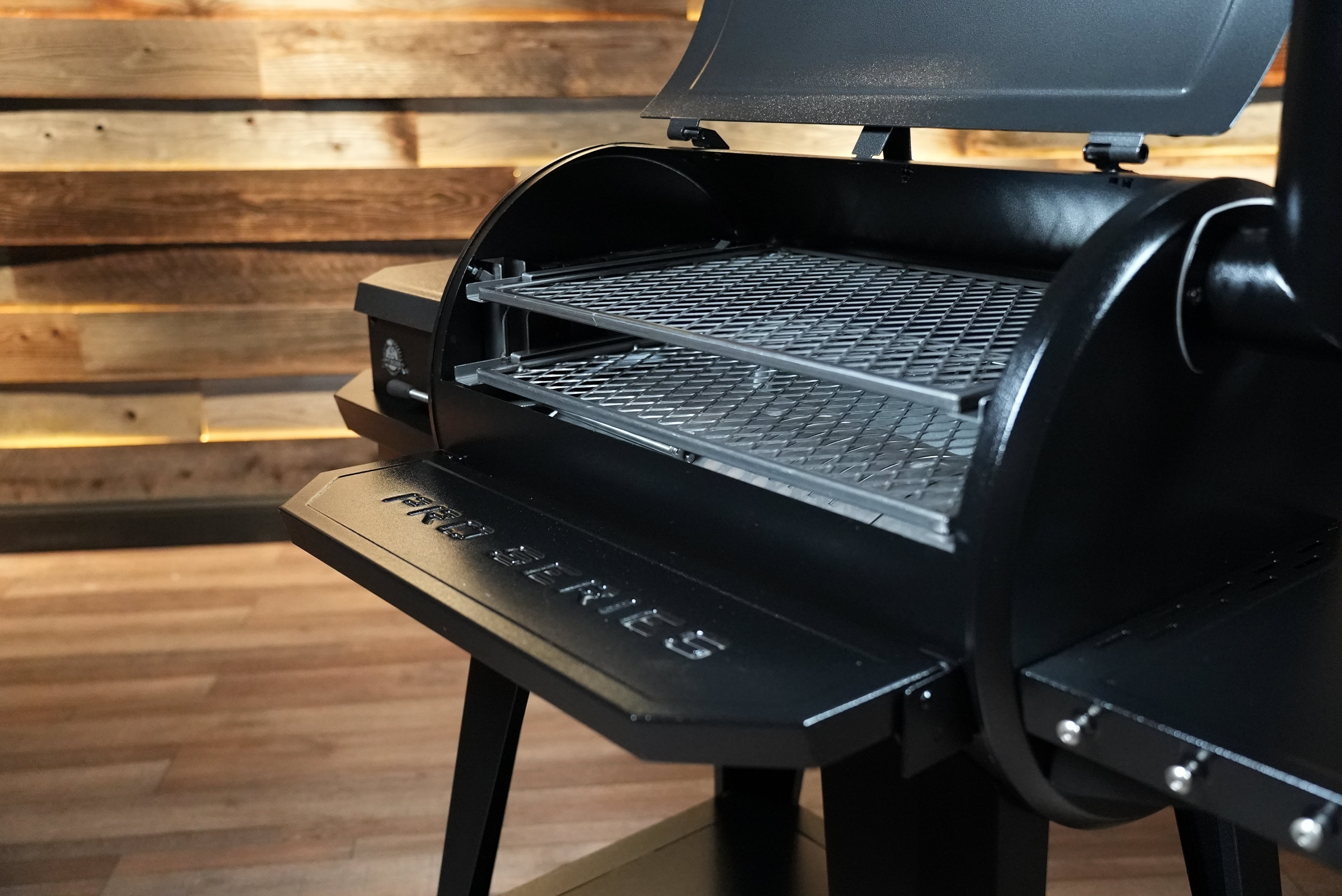 Black barbecue grill on a wooden floor