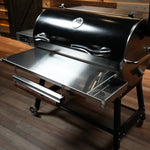 Barbecue grill on wheels with a wooden floor background