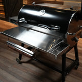 Barbecue grill on wheels with a wooden floor background