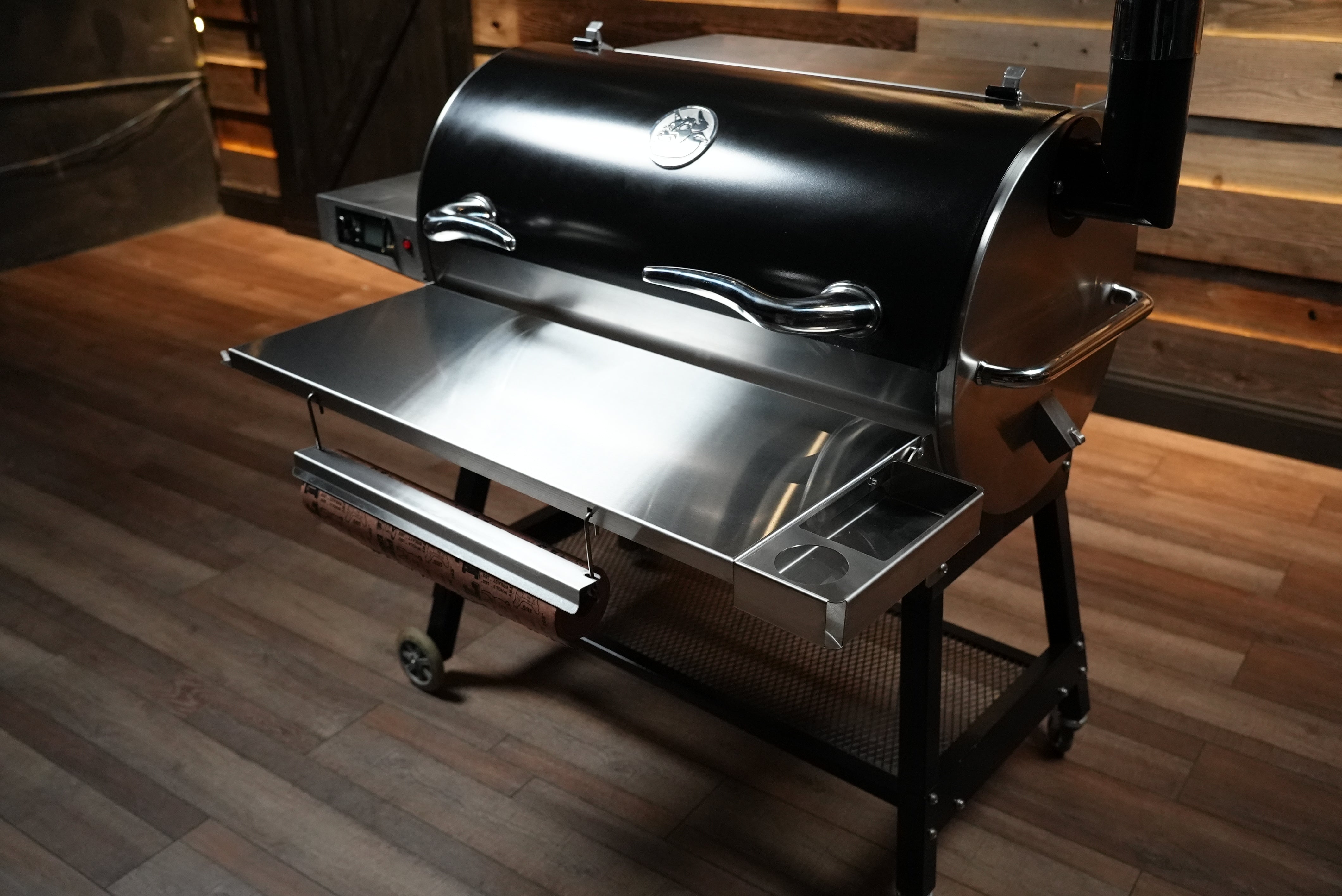 Barbecue grill on wheels with a wooden floor background